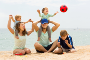 Family enjoying a safe summer beach day in Torrance with Life Saver Urgent Care support